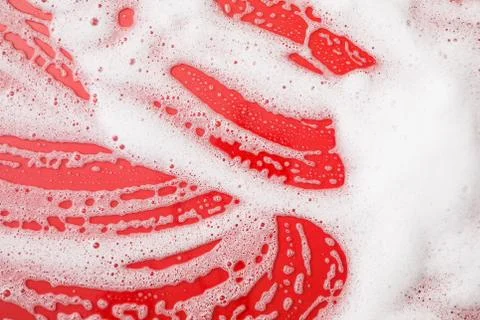 A red background with soap foam 写真素材