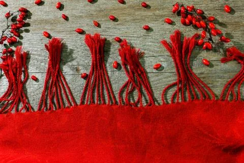 Red background for text. Red fabric with red berries on a wooden surface. Stock Photos
