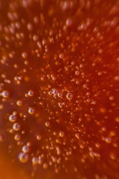 Red background, texture with bubbles in some liquid. Stock Photos
