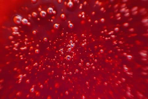 Red background, texture with bubbles in some liquid. Stock Photos