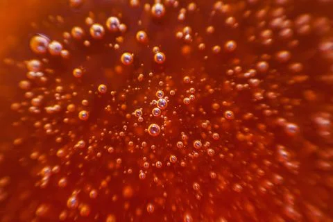 Red background, texture with bubbles in some liquid. Stock Photos