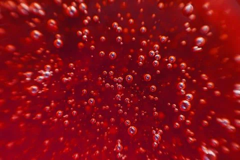 Red background, texture with bubbles in some liquid. Stock Photos