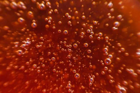 Red background, texture with bubbles in some liquid. Stock Photos