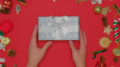 On a red background there is a gift box, women's hands open an empty box. Stock Footage 141882112