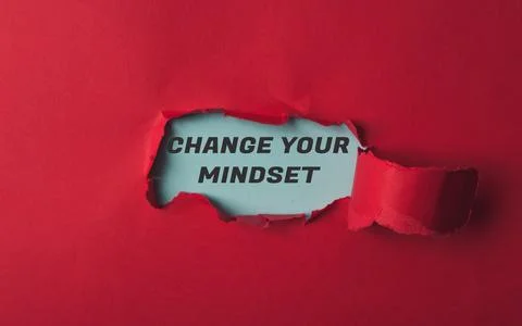 A red background with a torn piece of paper with the words Change Your Mindset Stock Photos