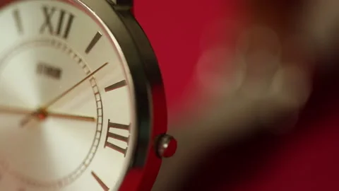 Red background with  watch, macro. Copy space, selective focus. Stock Footage 172448747