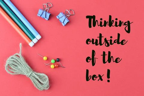 Red background written with THINKING OUTSIDE THE BOX Stock Photos