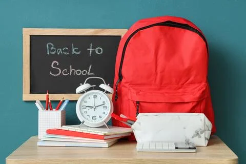 Red backpack and school supplies with back to school chalkboard message Stock Photos