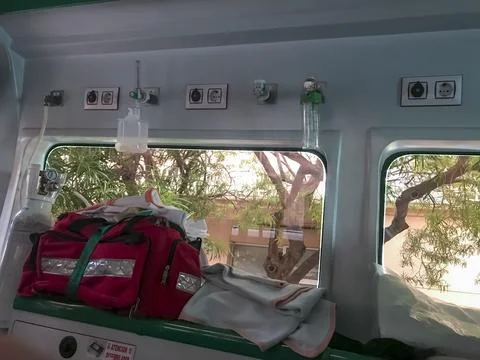 A red bag with a red strap is on the floor of an ambulance Stock Photos