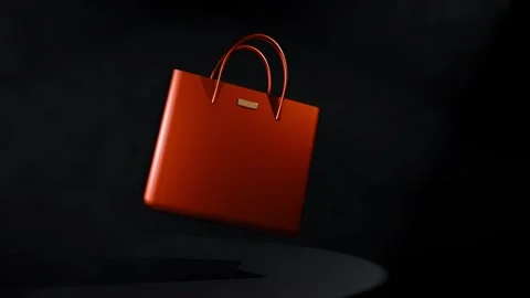 A red bag with sleek design and vibrant color under the spotlight Stock Footage 300679021