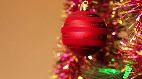 Red ball on the Christmas tree with blinking garlands in tinsel. Stock Footage 66358649