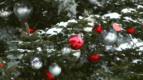 Red ball on the christmas tree during snowfall. Stock Footage