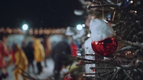 A red ball on a Christmas tree outside in winter in snowy weather at night Stock Footage 167339040