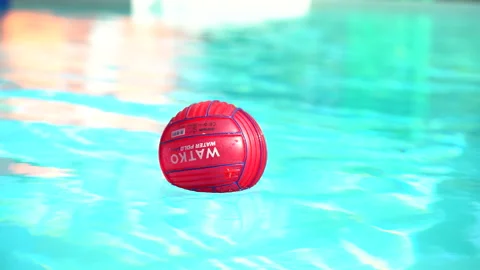 Red ball floating and moving in a crystal clear swimming pool Stock Footage 234863568