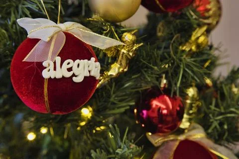 A red ball with the name Alejandra written on it hangs on a Christmas tree Stock Photos