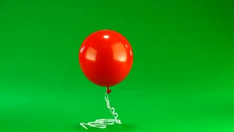 Red balloon on a green background Stock Footage 83917652