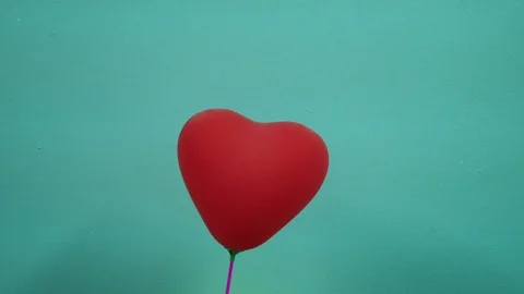Red balloon on green background. Stock Footage 116800930