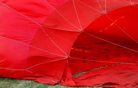 A red balloon with a red netting is open Foto stock