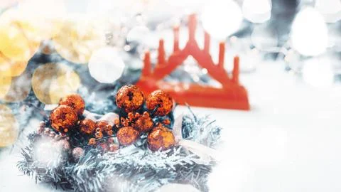 Red balloons and a triangular Christmas candle holder on a Christmas decorati Stock Photos