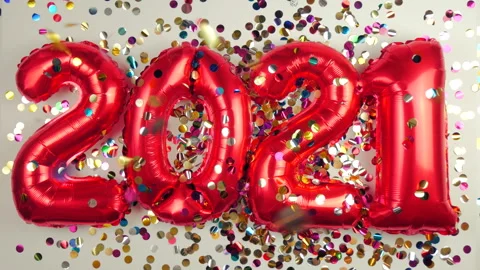 Red balloons in the form of numbers on a white background, falling confetti Stock Footage 144688891