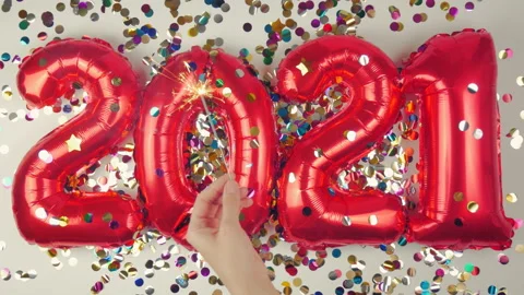 Red balloons in the form of numbers on a white background, falling confetti Stock Footage 144689207