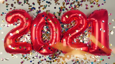 Red balloons in the form of numbers on a white background, falling confetti Stock Footage 144689307