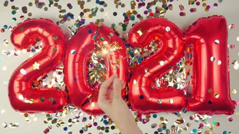Red balloons in the form of numbers on a white background, falling confetti Stock Footage 144689383