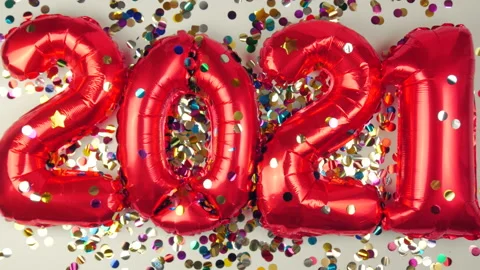 Red balloons in the form of numbers on a white background, falling confetti Stock Footage 144690061