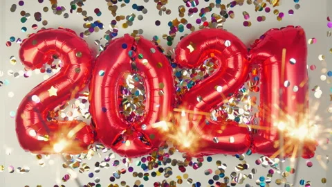 Red balloons in the form of numbers on a white background, falling confetti Stock Footage 144690417