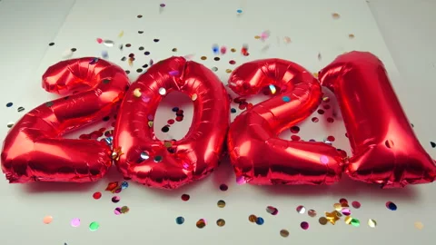 Red balloons in the form of numbers on a white background, falling confetti Stock Footage 144691735