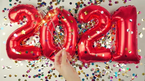 Red balloons in the form of numbers on a white background, falling confetti Stock Footage 144691767