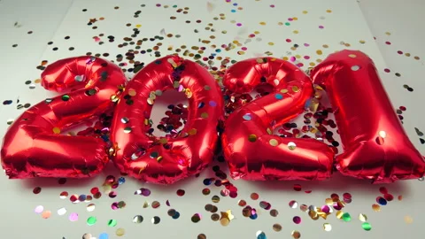 Red balloons in the form of numbers on a white background, falling confetti Stock Footage 144692023