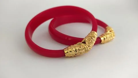 Red bangles isolated on white background - wedding  Traditional gold bangles Stock Photos