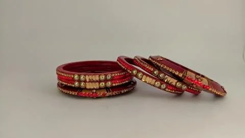 Red bangles isolated on white background - wedding  Traditional gold bangles Stock Photos