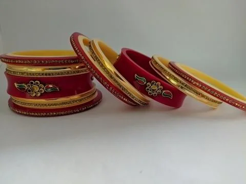 Red bangles isolated on white background - wedding  Traditional gold bangles Stock Photos