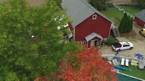 Red Barn _ Pan across green and orange trees Stock Footage 172041171