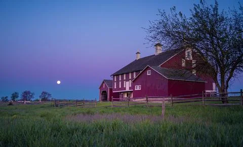 Red barn at Codori Farm in Gettysburg the Moon sets the purple morning sky Stock Photos
