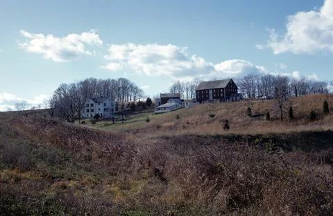 Red barn on distant hill 스톡 사진