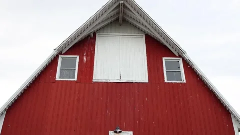 Red barn front with white trim and loft doors Stock Footage 338034913