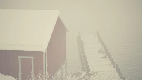 Red Barn Next to Snow-Covered Body of Water Stock-Illustration