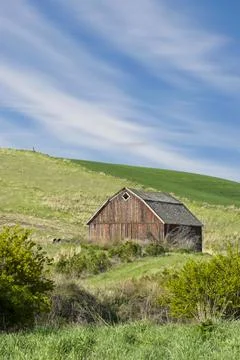 Red barn under a blue sky in eastern Washington. Stock Photos