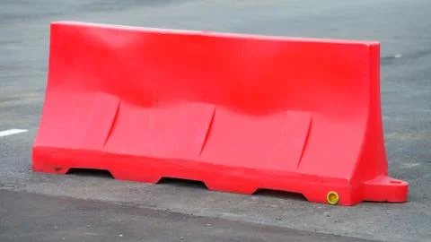 Red barriers made of plastic blocking the road. Do not cross Stock Photos