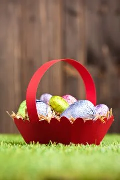 Red basket with chocolate easter eggs Stock Photos