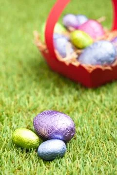 Red basket with chocolate easter eggs Stock Photos