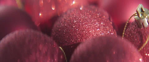 Red baubles with sequins on surface scope 4K sliding video Stock Footage 317479455