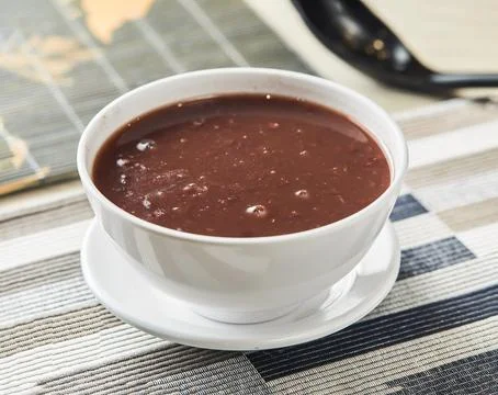 Red bean paste served in bowl isolated on napkin side view of chinese food Stock Photos