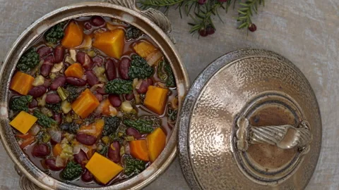 Red bean stew with vegetables: pumpkin, kale leaves, and carrot. Stock Footage 342348694