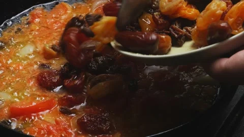 Red beans are stewed in tomato sauce, dried fruits are put in a frying pan... Stock Footage 296015864