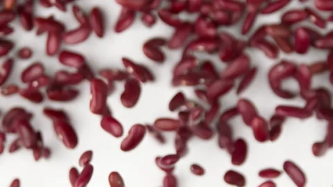 Red beans flies in slow motion on the white background Video stock 148553815