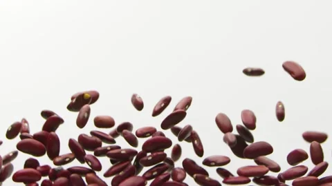 Red beans flying up and falling dawn on the white background slow motion Vídeo Stock 148554011